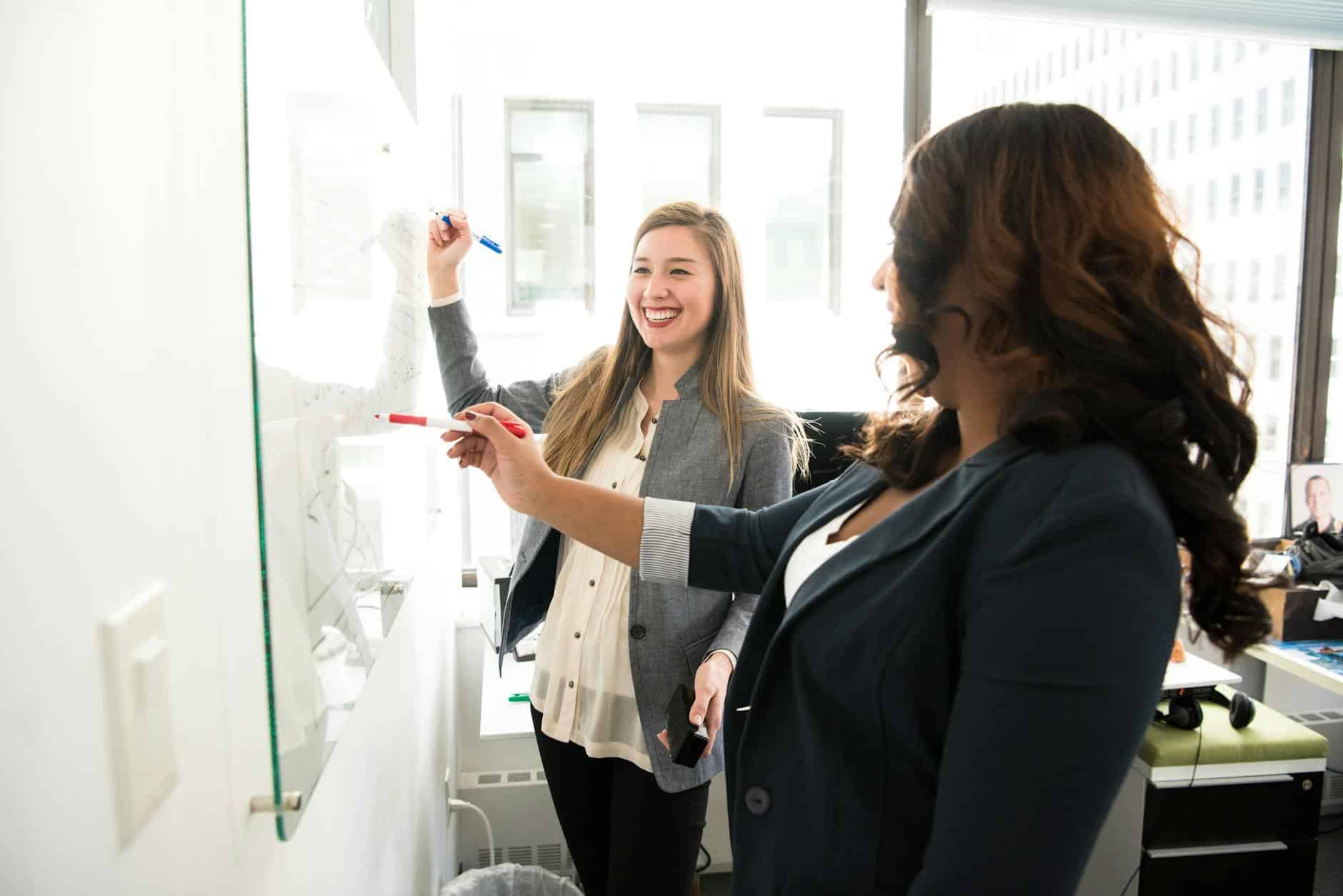 Two women resolving a workplace conflict with positive communication.