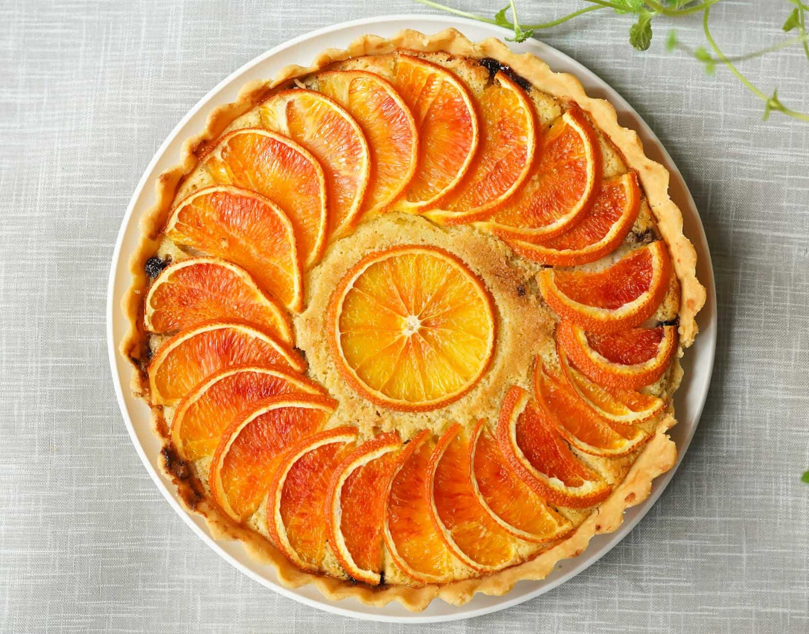 Delicious orange tart featuring a colorful citrus topping, perfect for dessert or special occasions.