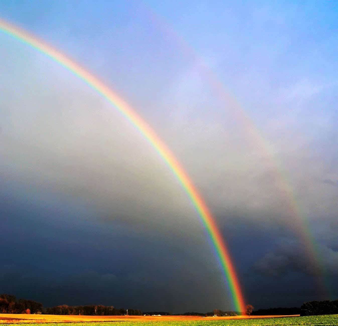 Rainbow over a stormy sky symbolizing hope and conflict resolution.