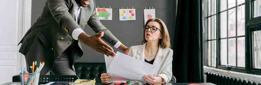 Mediation session between colleagues addressing office conflicts professionally.