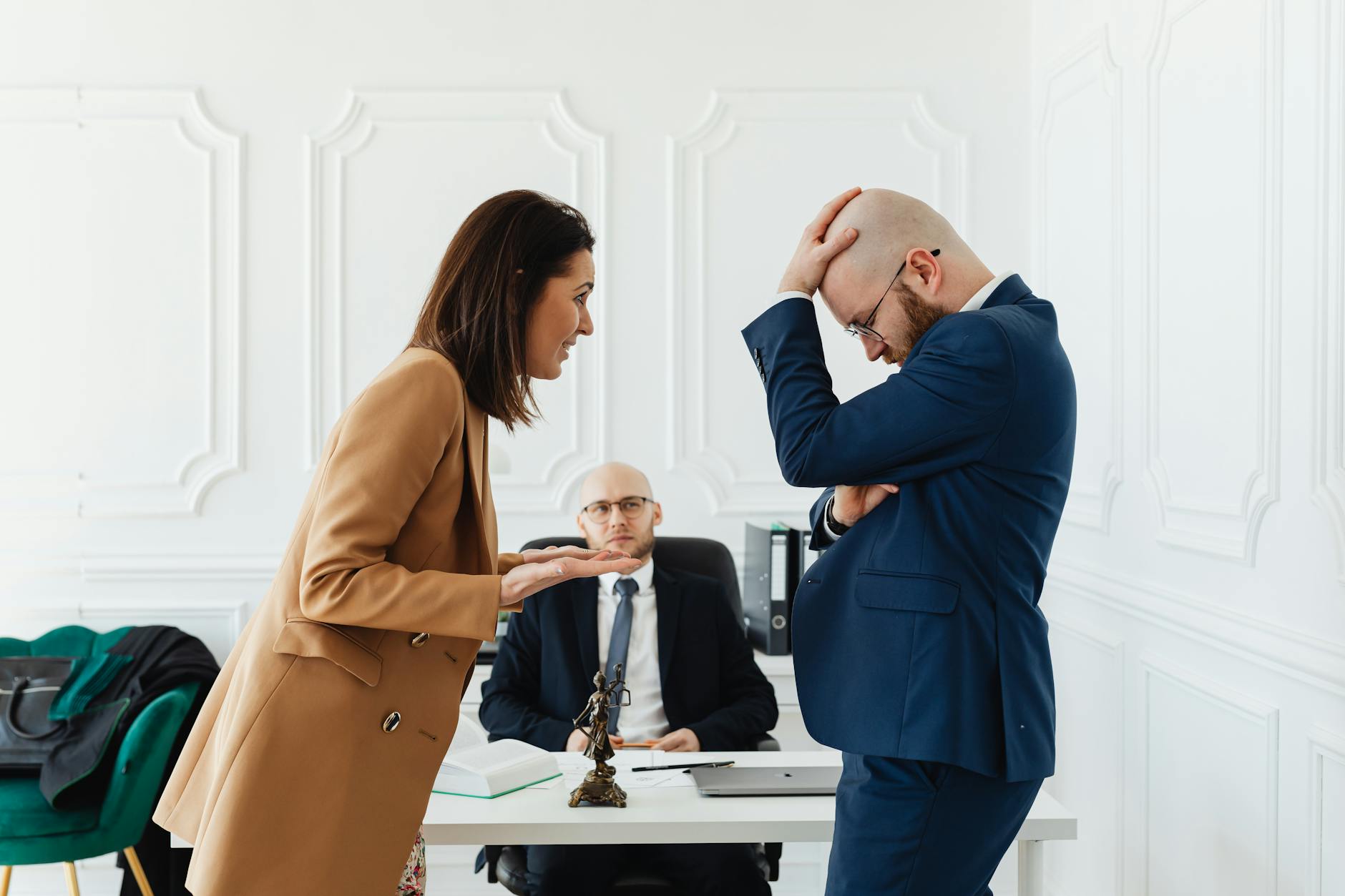 a couple discussing in front of a lawyer