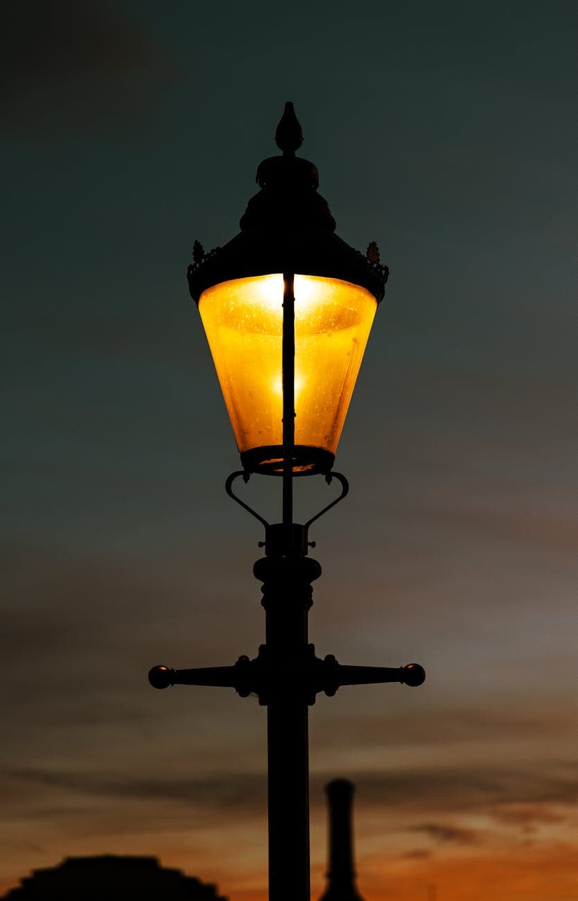 Streetlamp illuminating the evening sky, representing insight and conflict resolution.
